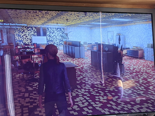 A screenshot of the game Control, with a red-headed player looking at a room entirely covered in yellow post-its